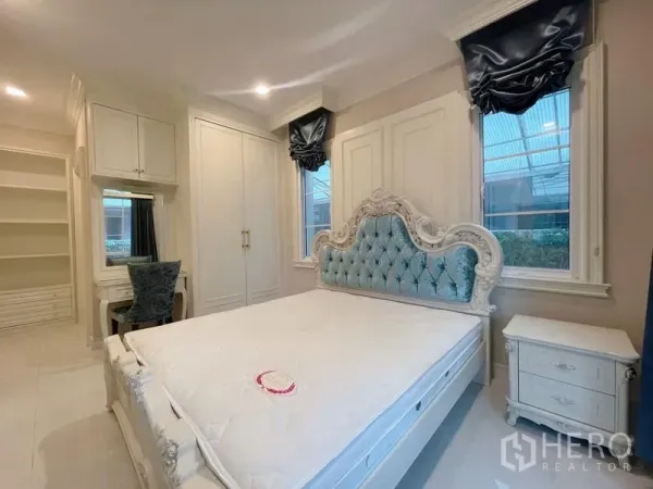 Detached House for rent or sale in Bang Phli, Samut Prakan - Elegant bedroom with tufted headboard, built‑in wardrobes, vanity desk, and soft lighting.