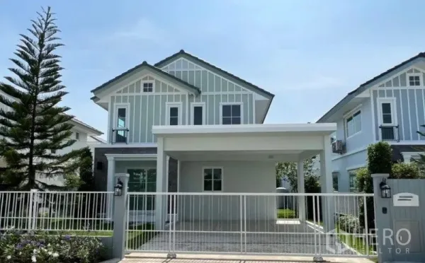 Detached House for rent in Min Buri, Bangkok - Front exterior of a two-storey detached house with gated driveway and covered carport.