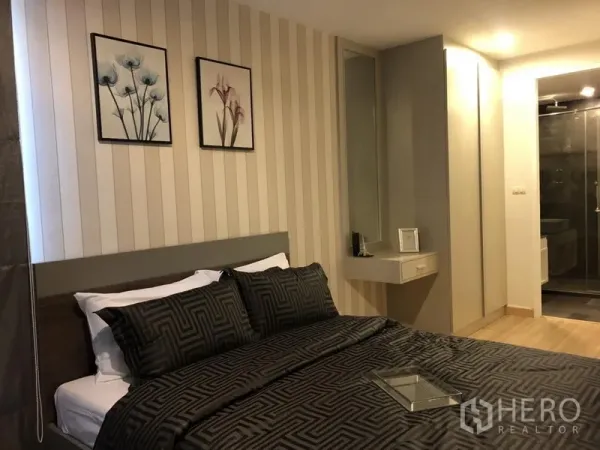 公寓 出租在Watthana, Bangkok - 第二卧室配深色床品、墙面装饰、内置衣柜、梳妆台与带淋浴套卫。