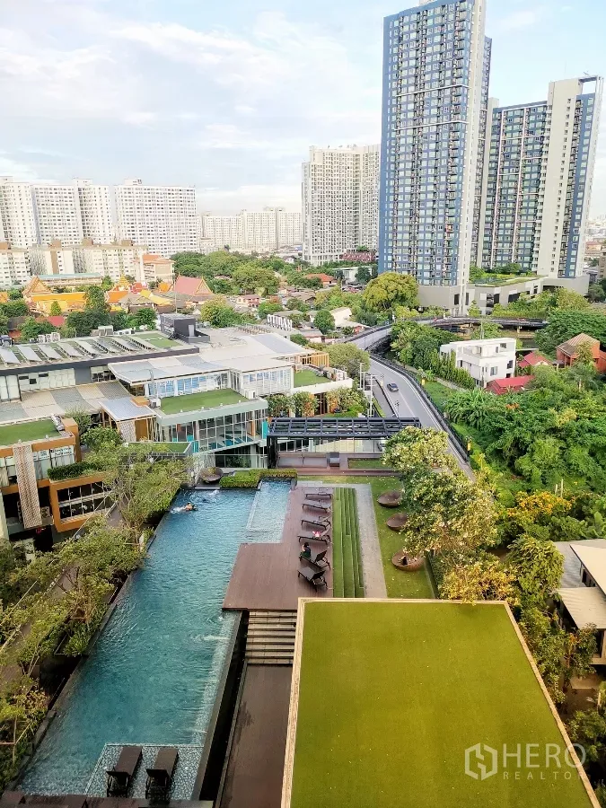 Condominium for rent or sale in Watthana, Bangkok - Aerial view of swimming pool deck, landscaped garden and Habito Mall within the community.