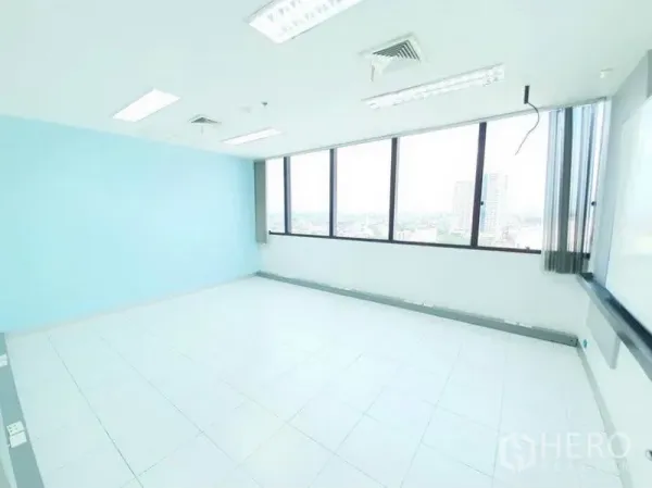 Office Space for rent in Bang Na, Bangkok - Open office with panoramic windows, blue wall and city skyline views.