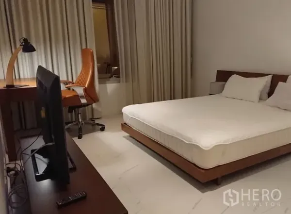 公寓 出租在Pathum Wan, Bangkok - 卧室另一角度，设工作桌、电视柜与全窗帘，安静舒适。