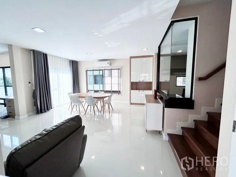 บ้าน ให้เช่าหรือขายในPrawet, Bangkok - โถงรับแขกโล่ง ชุดโต๊ะอาหาร บันไดและหน้าต่างบานกว้าง