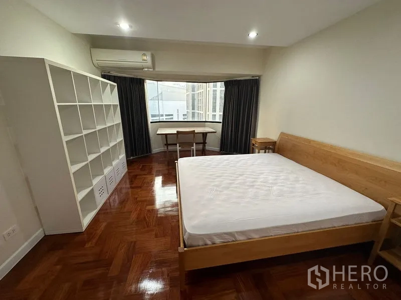 公寓 出租在Watthana, Bangkok - 卧室带凸窗，大型置物架、书桌与空调设备。