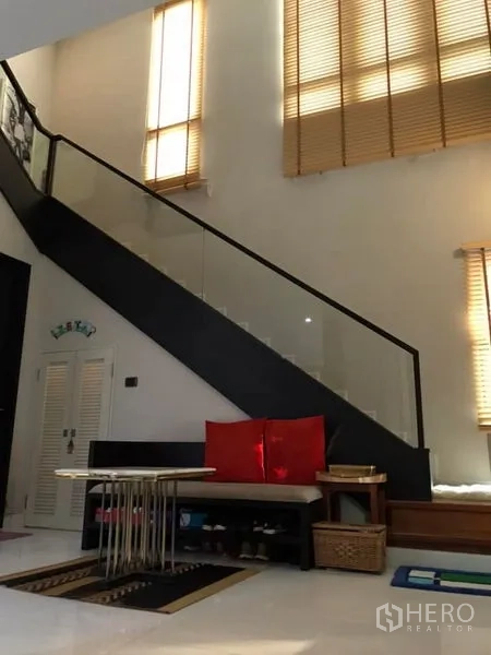 Detached House for sale in Saphan Sung, Bangkok - Double-height foyer featuring a glass-railed staircase and tall windows bringing natural light.