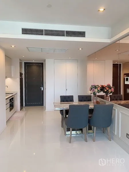 Condominium for sale - Dining zone adjacent to kitchen in a bright open-plan interior.