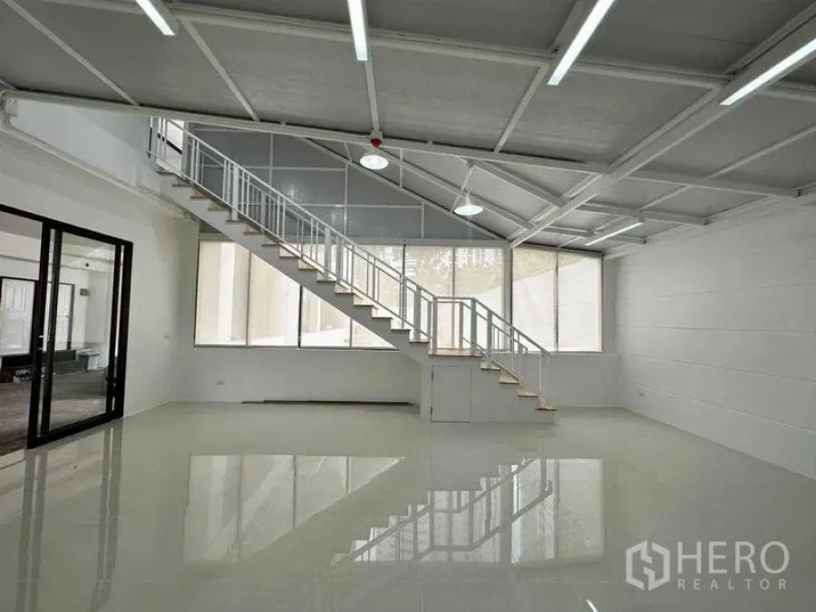Office Space for rent or sale in Khlong Toei, Bangkok - Bright open office with long staircase, high sloped ceiling and expansive windows.