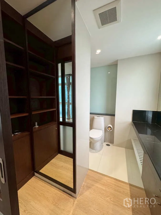 Condominium for rent or sale in Khlong Toei, Bangkok - Ensuite area with walk-in wardrobe, vanity and glass shower with toilet.