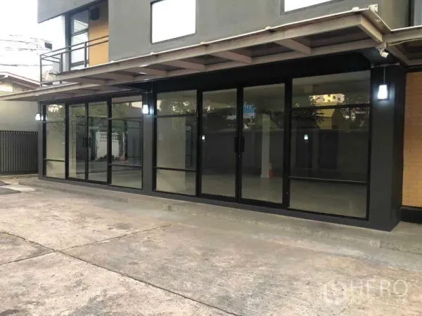 Office Space for rent in Phaya Thai, Bangkok - Modern ground-floor storefront facade with black-framed glass and canopy in Phaya Thai.