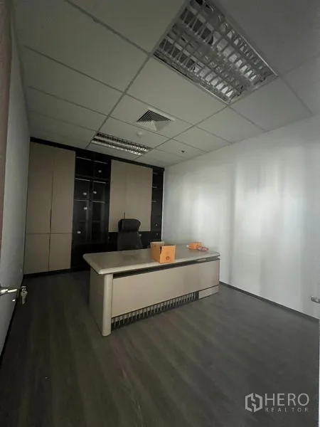 Office Space for rent in Huai Khwang, Bangkok - Executive suite featuring a modern desk, storage wall and white walls under a grid ceiling.