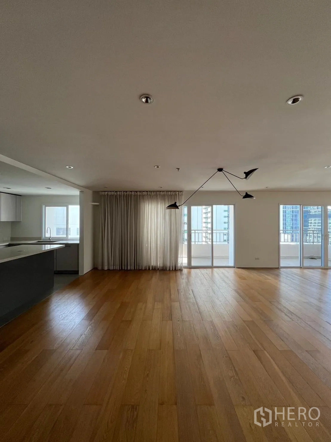 Condominium for rent or sale in Sathon, Bangkok - Spacious open-plan living and dining area with floor-to-ceiling windows and balcony access.