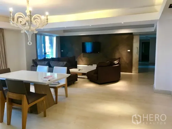 คอนโด ให้เช่าหรือขายในWatthana, Bangkok - มุมนั่งเล่นกว้าง พร้อมทีวีติดผนัง โซฟาตัวแอล และโต๊ะทานข้าวใกล้ประตูระเบียง