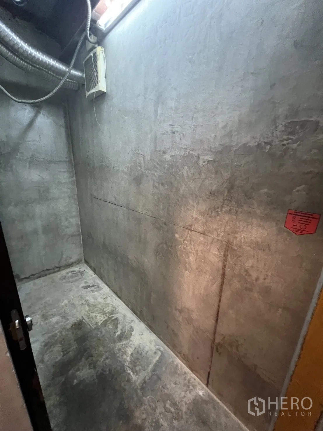 Retail Space for rent in Watthana, Bangkok - Concrete storage or utility room with ventilation duct and wall fan.