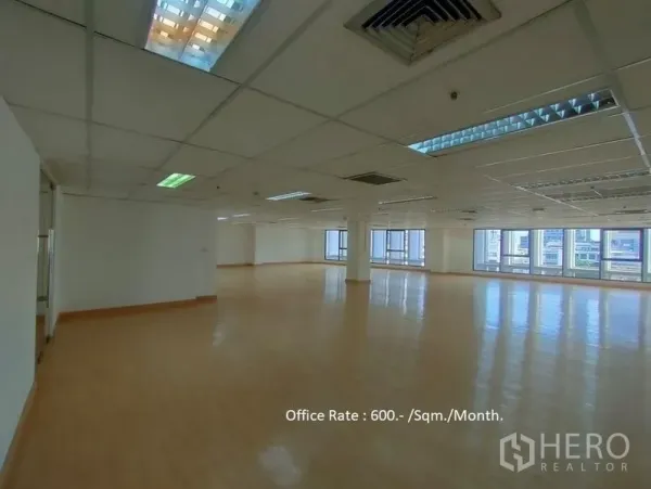 Office Space for rent in Bang Rak, Bangkok - Spacious open-plan office with wood-style flooring, drop ceiling lighting and large city-view windows in Bang Rak, Bangkok.