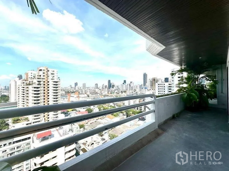 Condominium for rent in Watthana, Bangkok - Long balcony corridor with railing and panoramic city view.