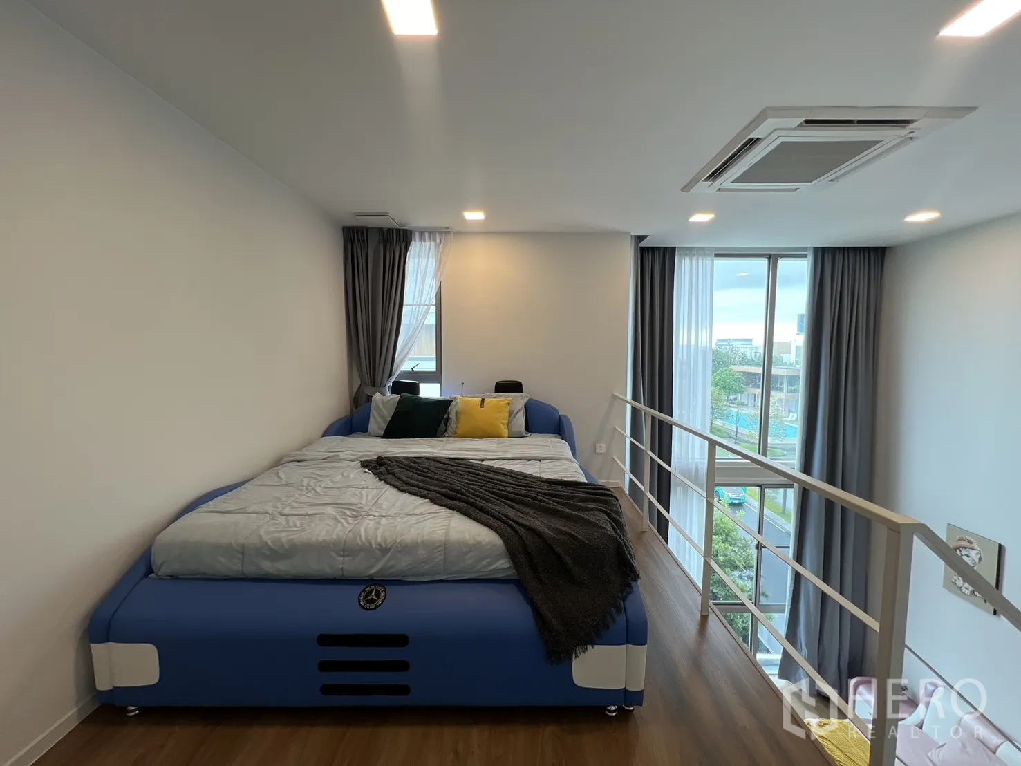 Detached House for rent in Saphan Sung, Bangkok - Bedroom corner showing stairs to loft and floor-to-ceiling glazing.