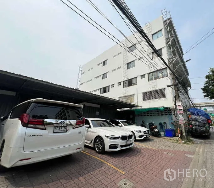 Office Space for rent - Rear exterior with covered parking bays beside the office block.