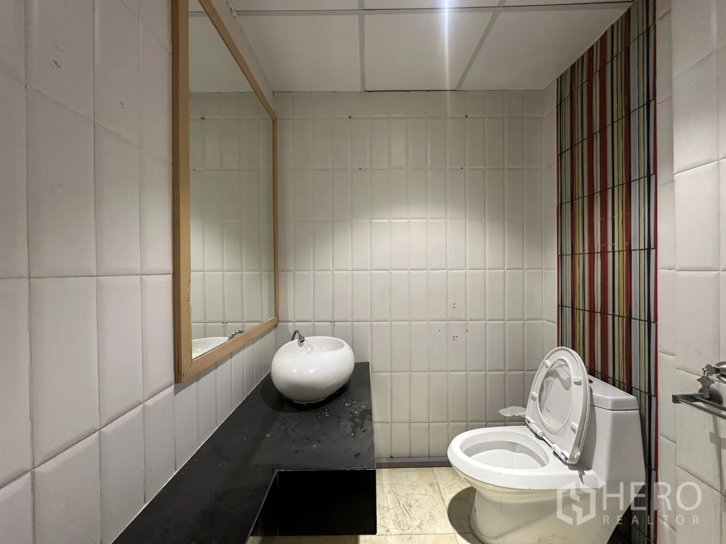 Retail Space for rent in Pathum Wan, Bangkok - Restroom with a large mirror, countertop basin, and toilet.