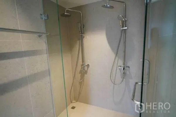 Condominium for rent or sale in Bang Na, Bangkok - Glass shower enclosure with twin rain showers and chrome fixtures.