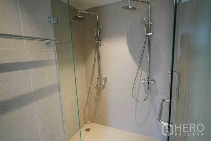 Condominium for rent or sale in Bang Na, Bangkok - Glass shower enclosure with twin rain showers and chrome fixtures.