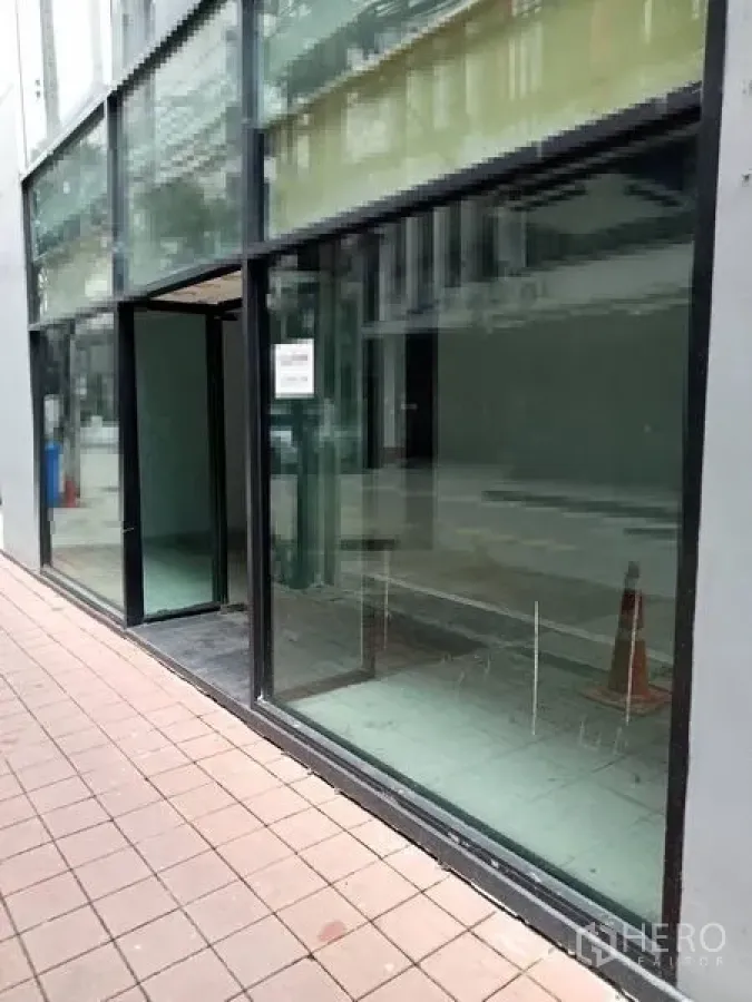 Retail Space for rent in Watthana, Bangkok - Street view of the glass shopfront and entrance along a pedestrian walkway.