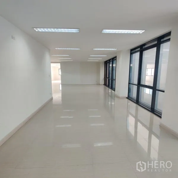Office Space for rent in Bang Kho Laem, Bangkok - Long open workspace with floor-to-ceiling windows along one side.