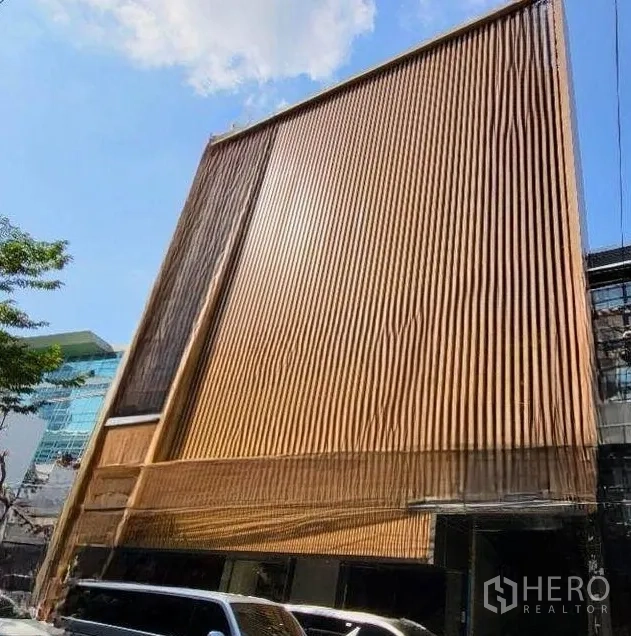 Retail Space for rent in Bang Rak, Bangkok - Modern building facade with vertical wooden slats and wide street frontage.