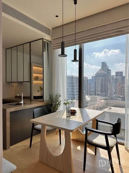 Condominium for rent in Pathum Wan, Bangkok - Bedside detail with modern sconce, wood wall and a compact vanity in the background.