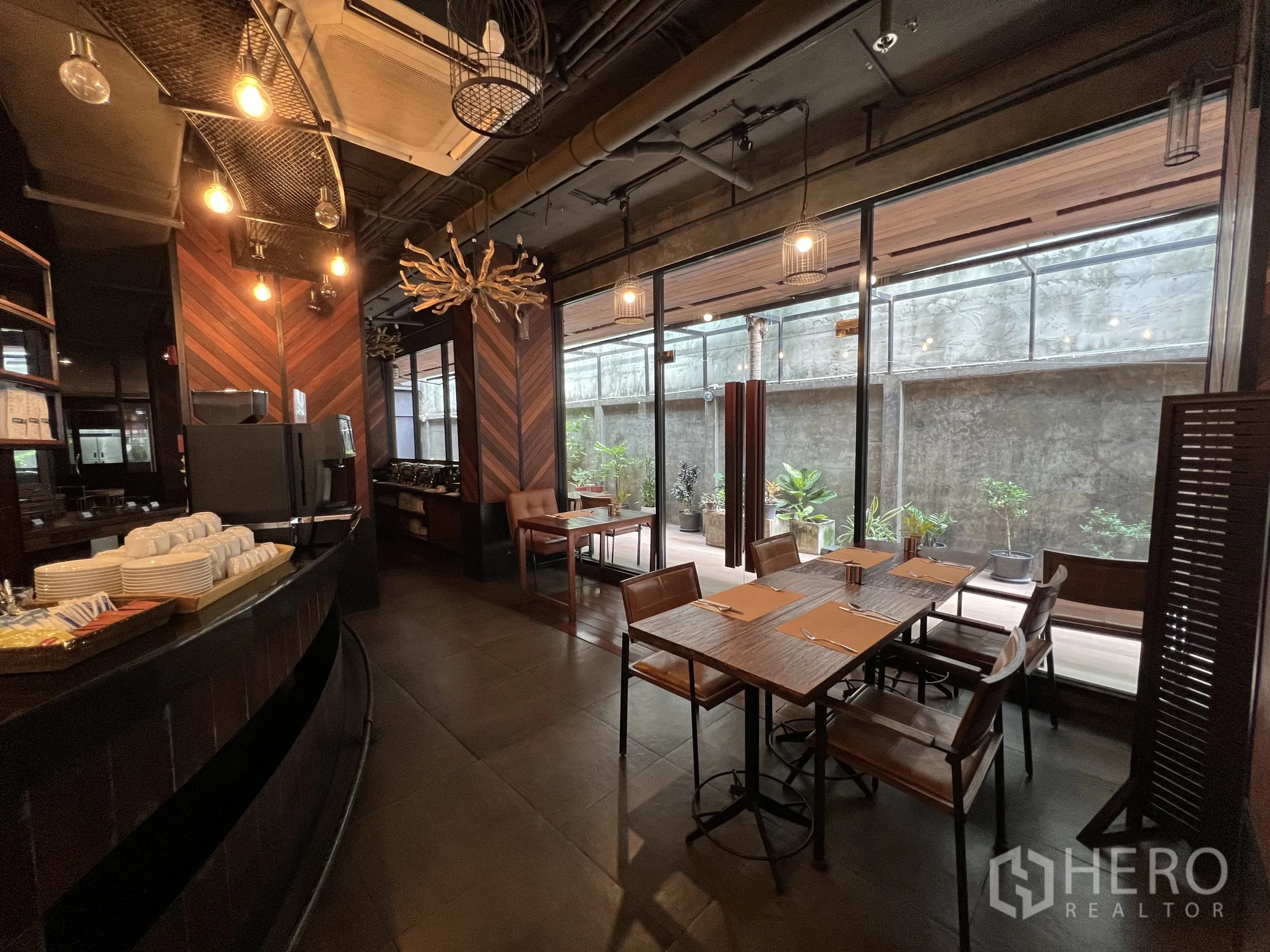 Retail Space for rent in Watthana, Bangkok - Cafe-style seating by full-height windows, bar counter, and chevron wood paneling.