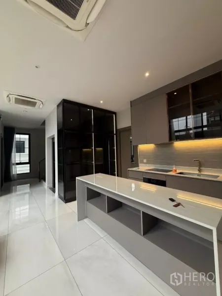Detached House for rent in Saphan Sung, Bangkok - Sleek open kitchen with long island, built-in cabinets and accent lighting.
