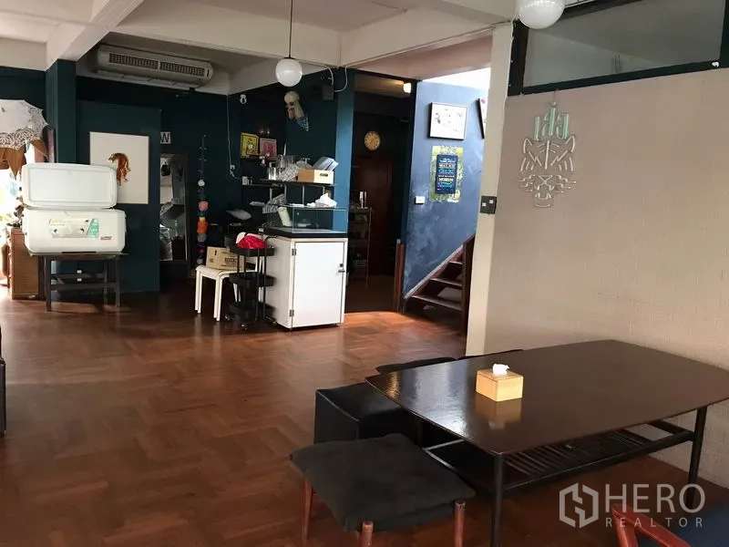 Retail Space for rent in Watthana, Bangkok - Spacious room with parquet flooring, a service station and stairs.