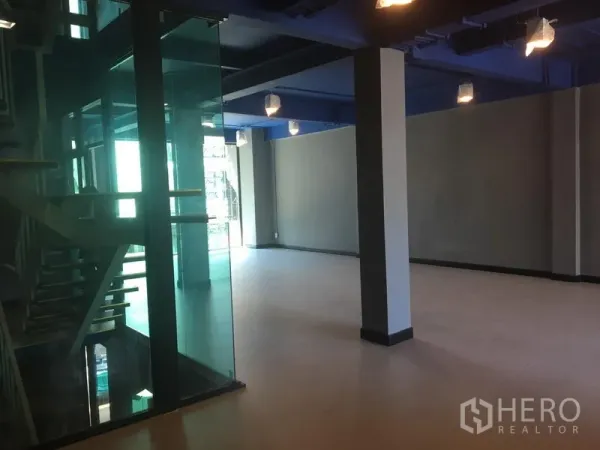 Retail Space for rent in Watthana, Bangkok - Spacious shop interior with floor-to-ceiling windows and a glass stairwell.