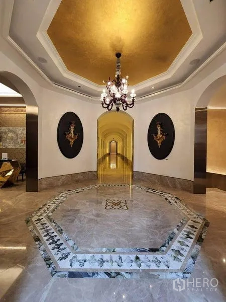 Condominium for rent or sale in Watthana, Bangkok - Grand condominium lobby with marble floors, arched hallways and a classic chandelier.