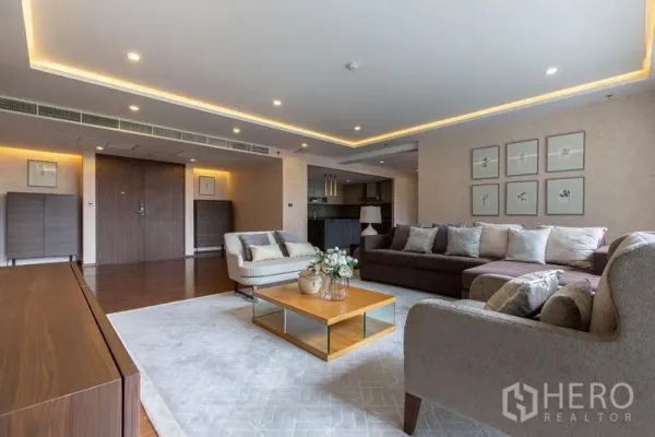 Condominium for rent or sale - Lounge area with recessed lighting, sectional sofa and view toward open kitchen.