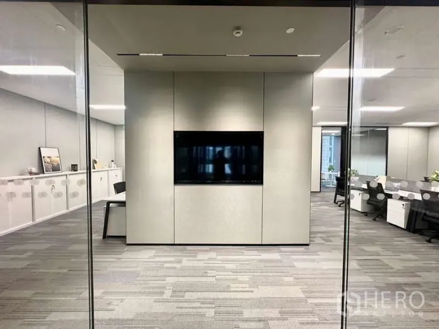 Office Space for rent in Bang Kapi, Bangkok - Glass-partitioned meeting area featuring a wall-mounted TV screen and built-in storage cabinets.