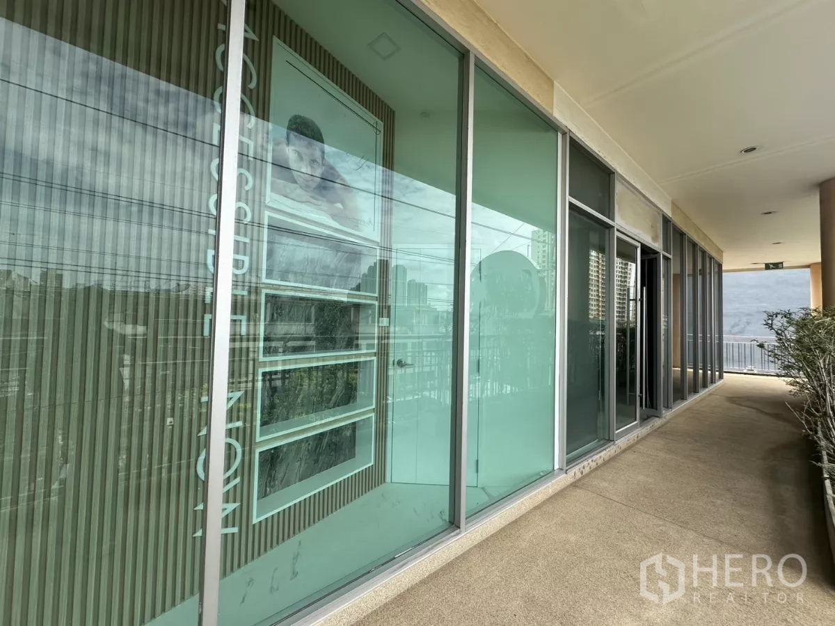 Retail Space for rent in Phra Khanong, Bangkok - Covered outdoor corridor with floor‑to‑ceiling glass storefront overlooking city.