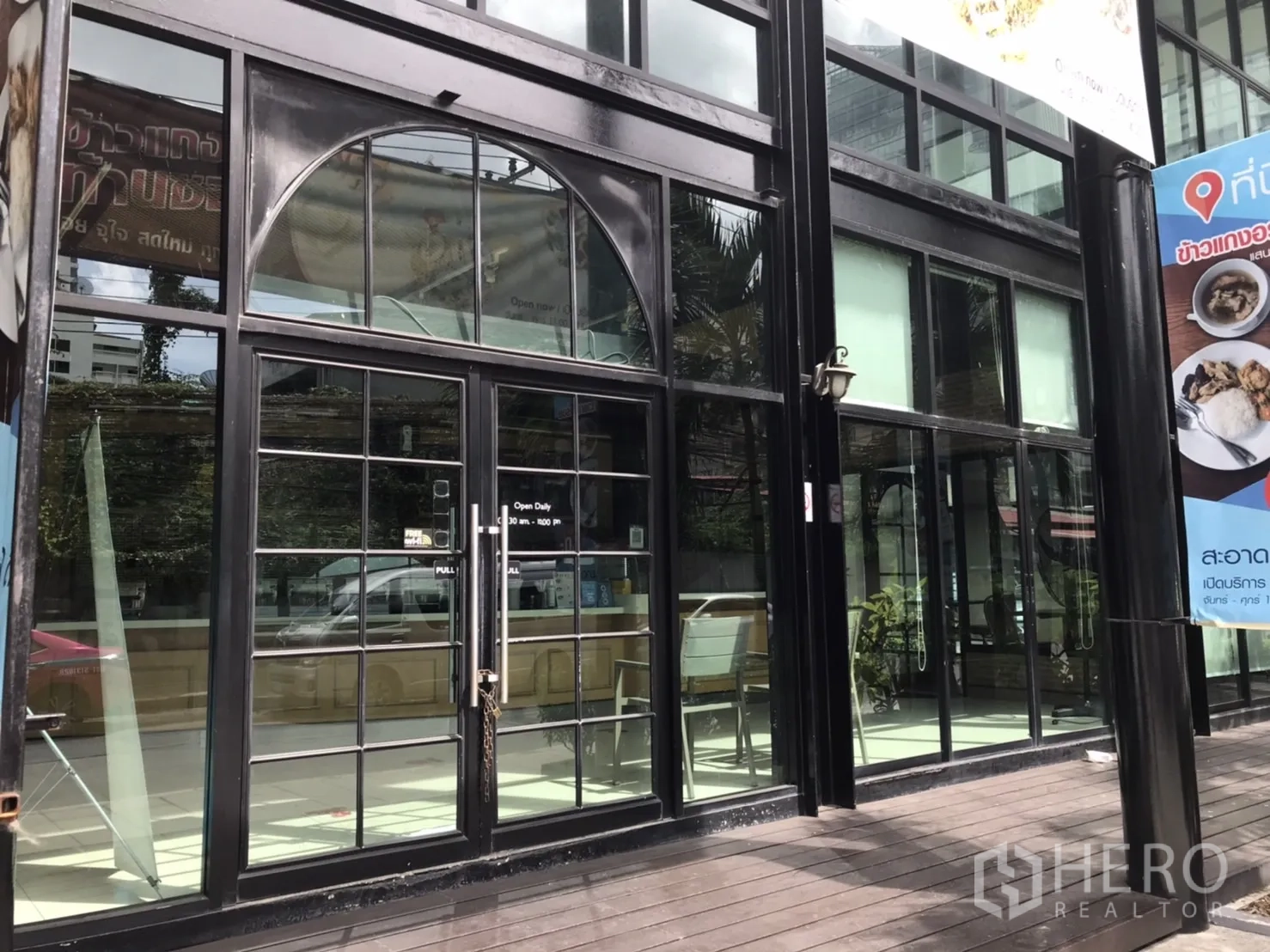 Retail Space for rent in Khlong Toei, Bangkok - Close-up of glass double doors and storefront windows with black metal frames.