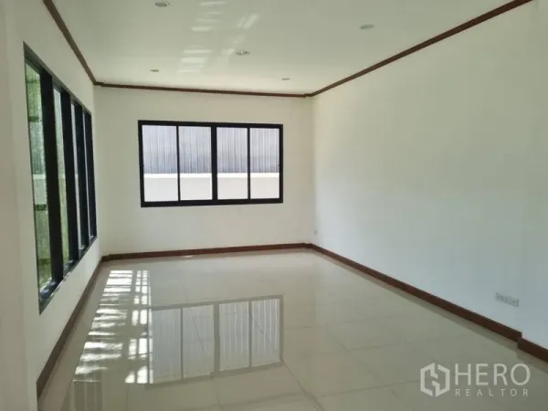 Warehouse for rent or sale in Krathum Baen, Samut Sakhon - Bright tiled office room with black aluminum windows and white walls letting in natural light.