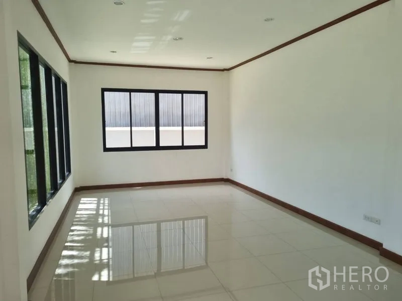 Warehouse for rent or sale in Krathum Baen, Samut Sakhon - Bright tiled office room with black aluminum windows and white walls letting in natural light.