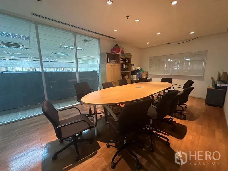 Office Space for rent - Conference room with oval table, whiteboard and recessed lights