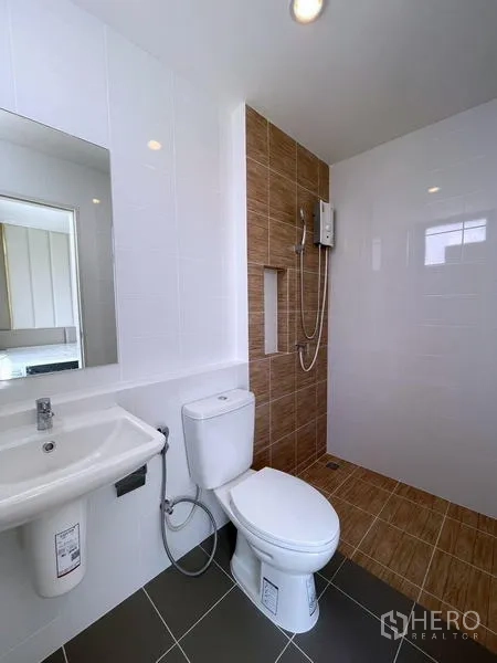 Townhouse for rent in Bang Phli, Samut Prakan - Clean bathroom with walk-in shower, water heater and white fixtures.