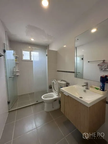 Detached House for sale in Sai Mai, Bangkok - Upper bathroom with glass shower enclosure, vanity and toilet.