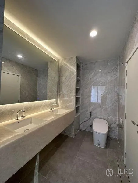 Townhouse for rent in Yan Nawa, Bangkok - Contemporary bathroom with long double-sink vanity and backlit mirror.