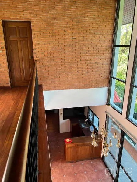 Detached House for rent in Bang Phli, Samut Prakan - View from mezzanine to double-height living area with full-height windows and chandelier.