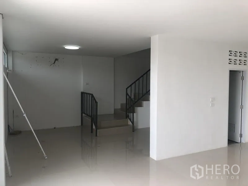 Factory for rent in Sai Noi, Nonthaburi - Ground-floor office and reception area with staircase and ample open space.