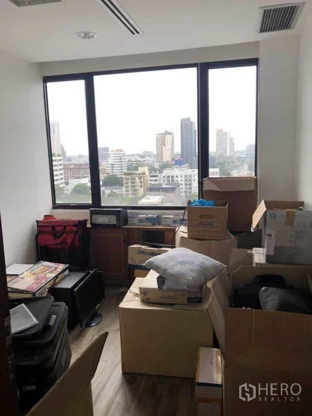 Office Space for sale in Watthana, Bangkok - Compact room with a large window and city view, used as storage.
