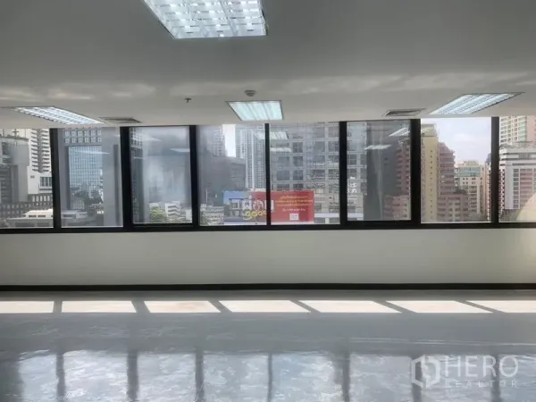 Office Space for rent in Bang Rak, Bangkok - Panoramic Bangkok skyline seen through a long row of office windows.