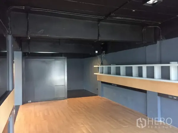 Retail Space for rent in Khlong Toei, Bangkok - Retail unit interior showing display ledge, exposed ceiling services and timber flooring.