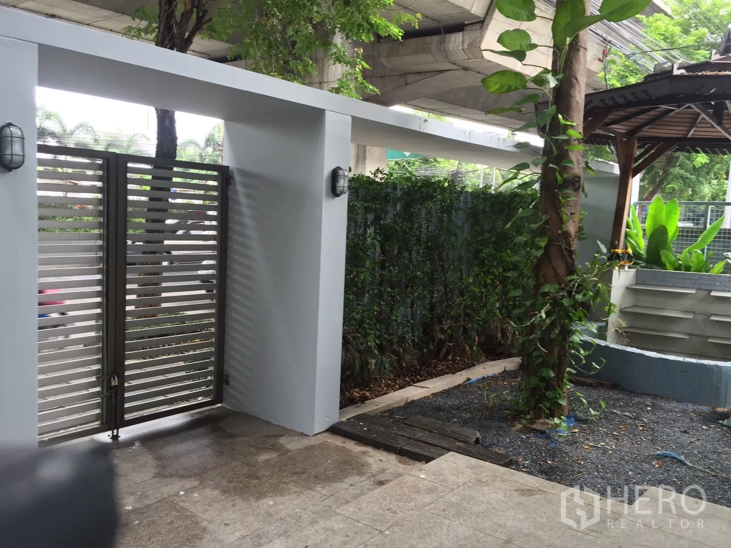 带办公室的家 出租或出售在Suan Luang, Bangkok - 花园入口带大门与凉亭，绿篱与攀援植物。