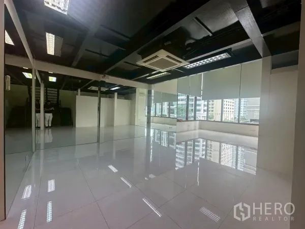 办公空间 出租在Khlong Toei, Bangkok - 开放式办公区，镜面墙、大窗与高光地面。